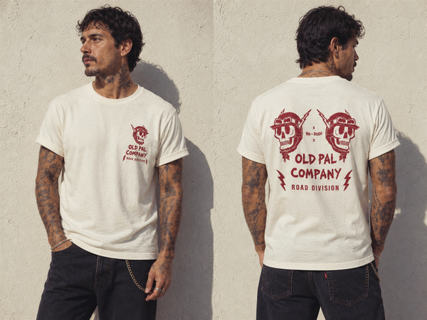 Male model wearing Classic White Old Pal Company Road Division T-shirt with black jeans and vintage-inspired styling