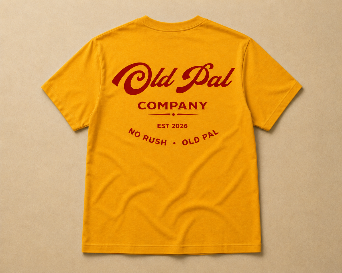 Mustard heavyweight cotton t-shirt with oversized red old pal company graphic laid flat on neutral background